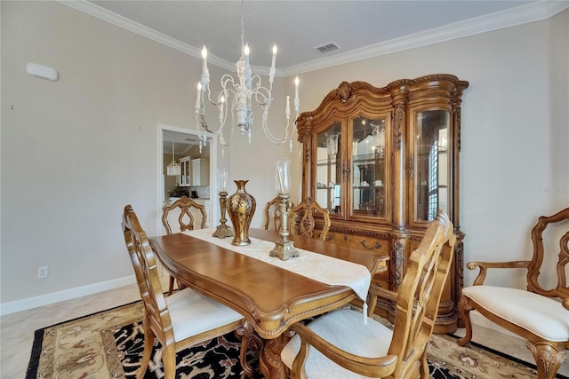 dining area featuring an inviting chandelier, baseboards, ornamental molding, and visible vents