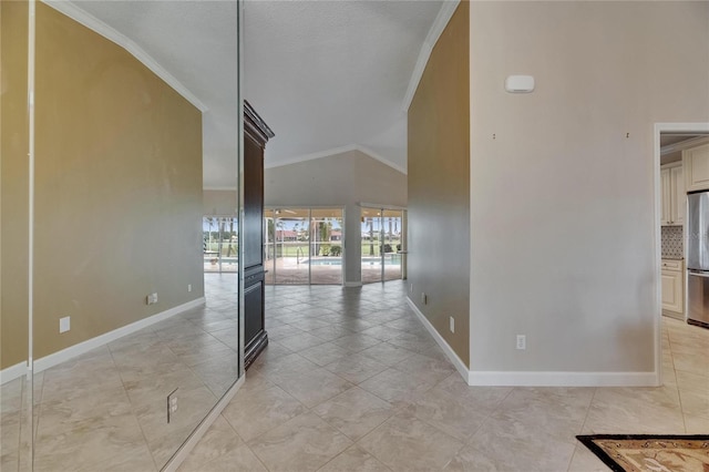 interior space featuring high vaulted ceiling, light tile patterned floors, baseboards, and crown molding