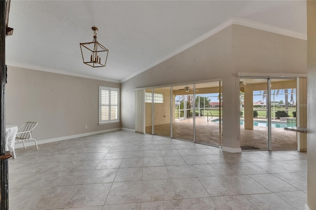 empty room with high vaulted ceiling, light tile patterned floors, baseboards, and ornamental molding