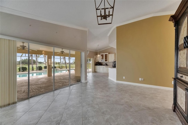 unfurnished living room featuring crown molding, ceiling fan, light tile patterned floors, lofted ceiling, and baseboards