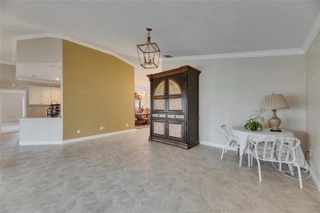 dining room with an inviting chandelier, baseboards, and ornamental molding