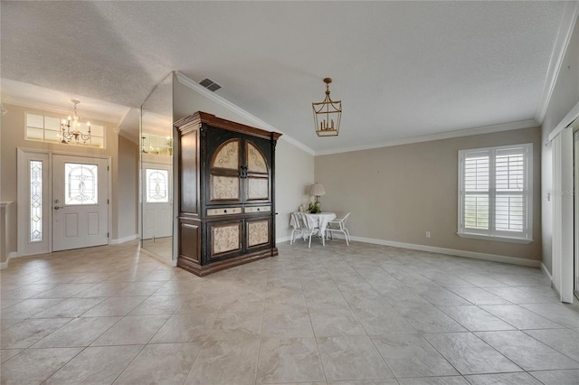 entrance foyer with a notable chandelier, baseboards, visible vents, and crown molding