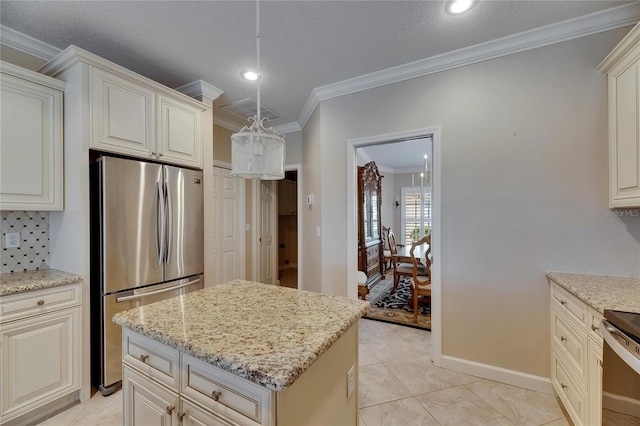 kitchen with crown molding, freestanding refrigerator, stove, a center island, and light stone counters