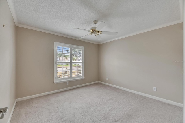 carpeted empty room with crown molding, ceiling fan, baseboards, and a textured ceiling