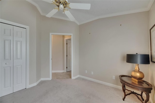 bedroom with a closet, light colored carpet, baseboards, and ornamental molding