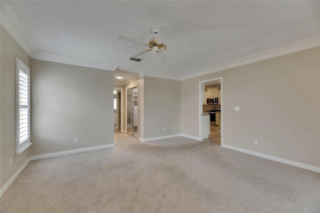 spare room with light colored carpet, a ceiling fan, ornamental molding, visible vents, and baseboards