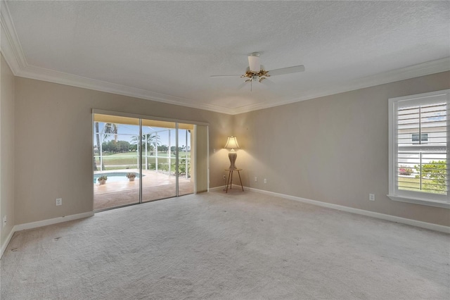 spare room with crown molding, ceiling fan, and baseboards