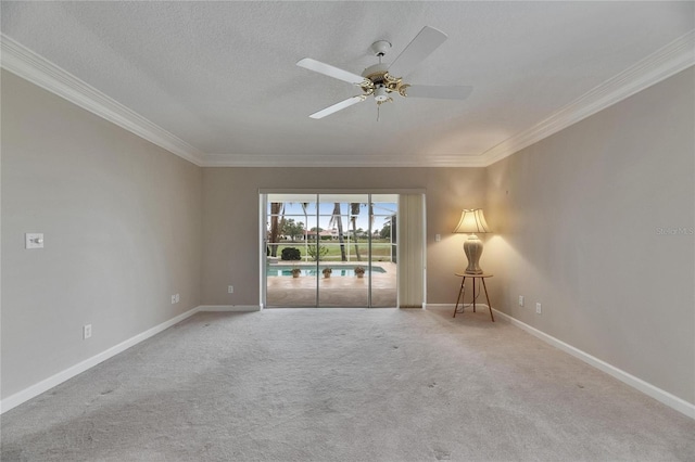 unfurnished room featuring crown molding, ceiling fan, baseboards, and carpet floors