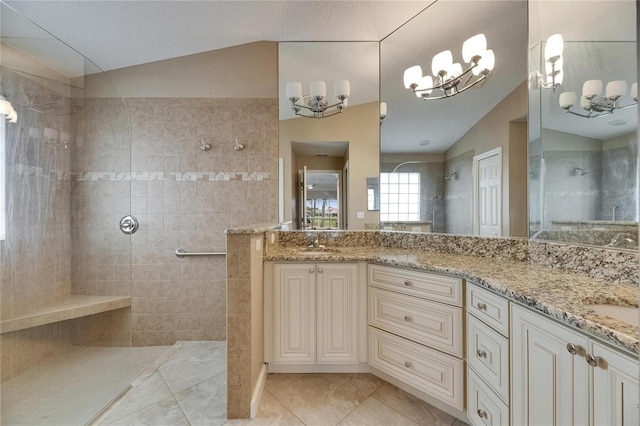 bathroom with a walk in shower, tile patterned flooring, an inviting chandelier, and lofted ceiling
