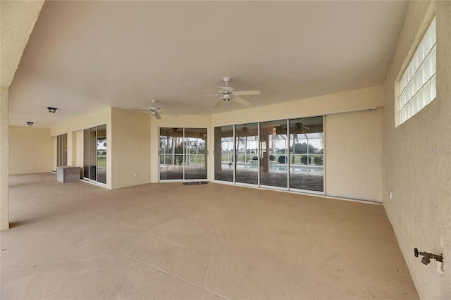 exterior space with concrete flooring, a wealth of natural light, and ceiling fan