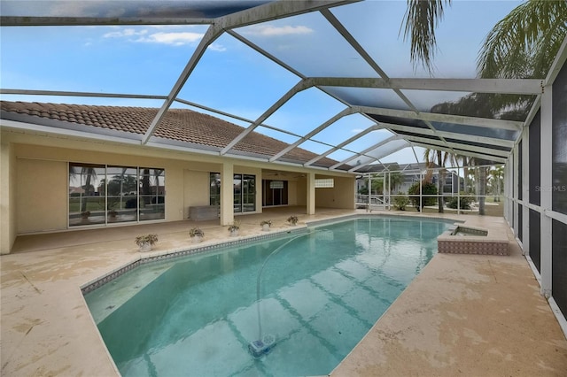 pool with a patio area and glass enclosure