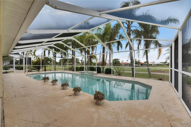 view of pool with a lanai, a patio, and a pool with connected hot tub