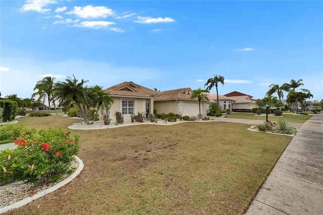 view of front facade featuring a front lawn, driveway, a garage, and stucco siding