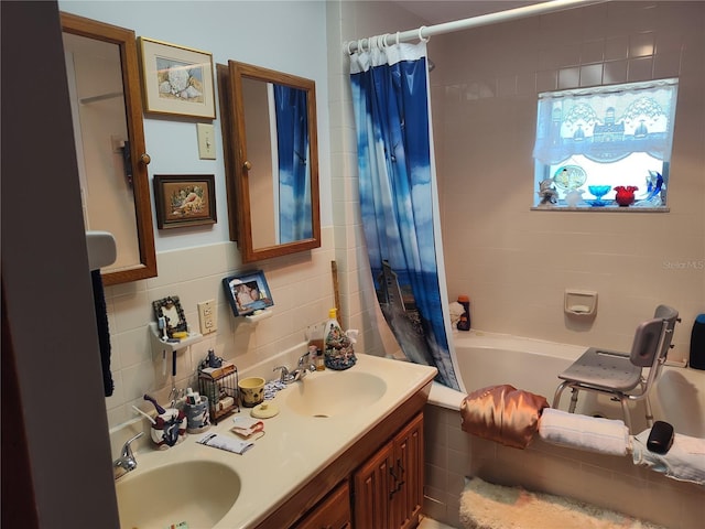 bathroom featuring a sink, tile walls, double vanity, and shower / tub combo with curtain