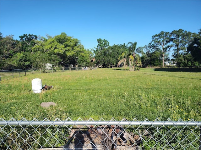 view of yard featuring fence and a rural view