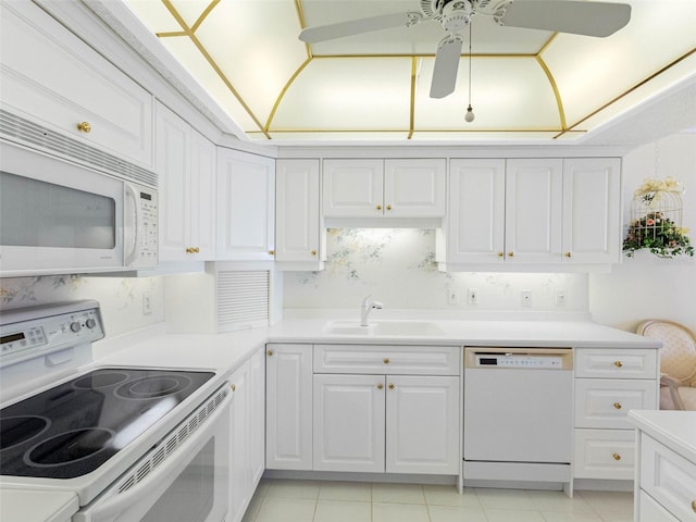 1400 Gulf Blvd Unit 511, Clearwater Beach, FL 33767 - kitchen featuring white appliances, a ceiling fan, white cabinets, light countertops, and a sink
