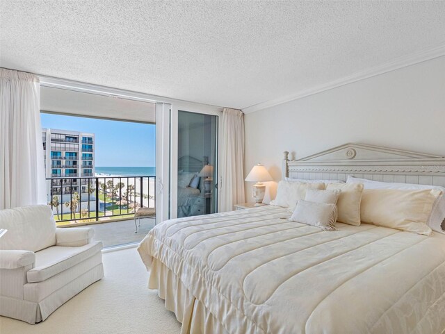 1400 Gulf Blvd Unit 511, Clearwater Beach, FL 33767 - carpeted bedroom with a water view, ornamental molding, a wall of windows, a textured ceiling, and access to outside