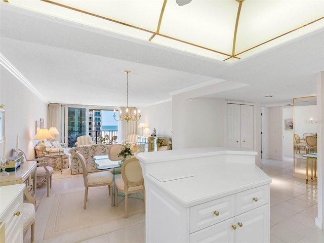 1400 Gulf Blvd Unit 511, Clearwater Beach, FL 33767 - kitchen featuring crown molding, open floor plan, white cabinetry, and light tile patterned floors