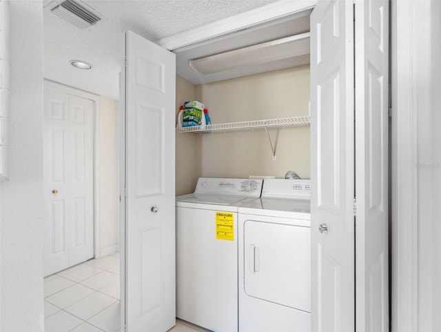 1400 Gulf Blvd Unit 511, Clearwater Beach, FL 33767 - laundry room featuring visible vents, laundry area, a textured ceiling, independent washer and dryer, and light tile patterned flooring