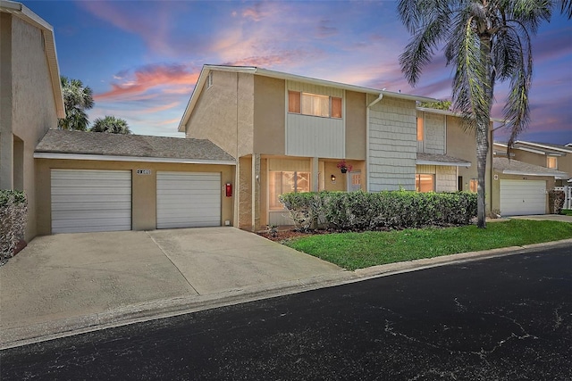 6490 Cape Hatteras Way NE Unit 4, Saint Petersburg, FL 33702 - view of front facade with a garage, stucco siding, and concrete driveway