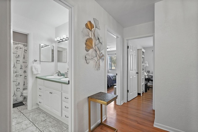 6490 Cape Hatteras Way NE Unit 4, Saint Petersburg, FL 33702 - bathroom with vanity, a textured wall, ensuite bathroom, toilet, and wood finished floors