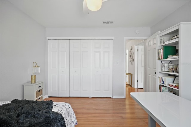 6490 Cape Hatteras Way NE Unit 4, Saint Petersburg, FL 33702 - bedroom with light wood-style floors, visible vents, a closet, and baseboards