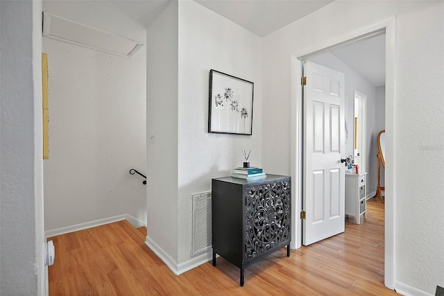 6490 Cape Hatteras Way NE Unit 4, Saint Petersburg, FL 33702 - corridor featuring visible vents, baseboards, light wood finished floors, and attic access