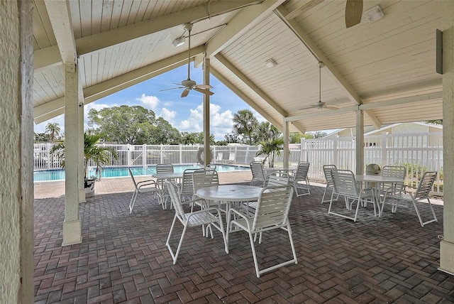6490 Cape Hatteras Way NE Unit 4, Saint Petersburg, FL 33702 - view of patio with a community pool, ceiling fan, a fenced backyard, and outdoor dining area