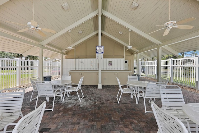 6490 Cape Hatteras Way NE Unit 4, Saint Petersburg, FL 33702 - view of patio featuring a fenced backyard, ceiling fan, and outdoor dining area