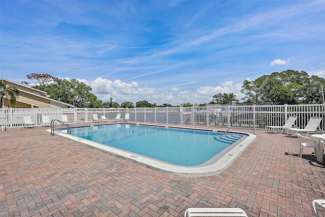 6490 Cape Hatteras Way NE Unit 4, Saint Petersburg, FL 33702 - community pool with a patio and fence