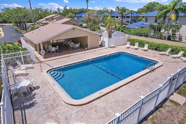 6490 Cape Hatteras Way NE Unit 4, Saint Petersburg, FL 33702 - community pool featuring a patio area, a fenced backyard, and a residential view