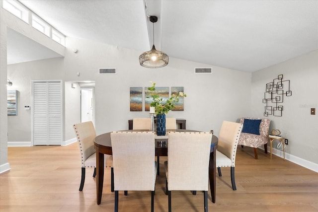 dining area with light wood-type flooring and baseboards