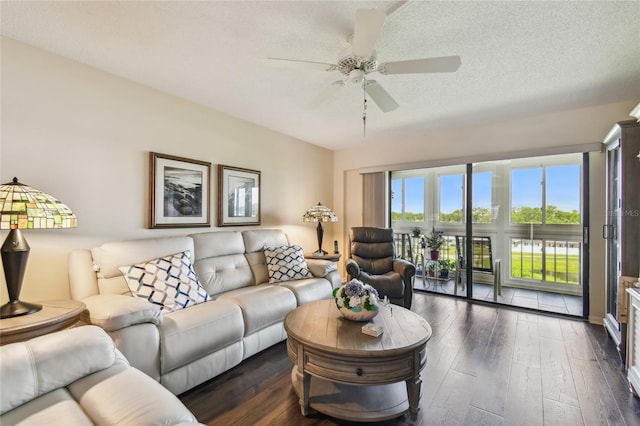 living room with hardwood / wood-style floors, ceiling fan, and a textured ceiling