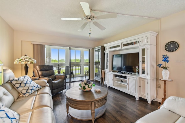 living room with ceiling fan, a textured ceiling, baseboards, and dark wood-style floors