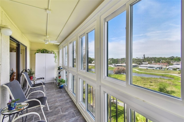 sunroom / solarium with a water view
