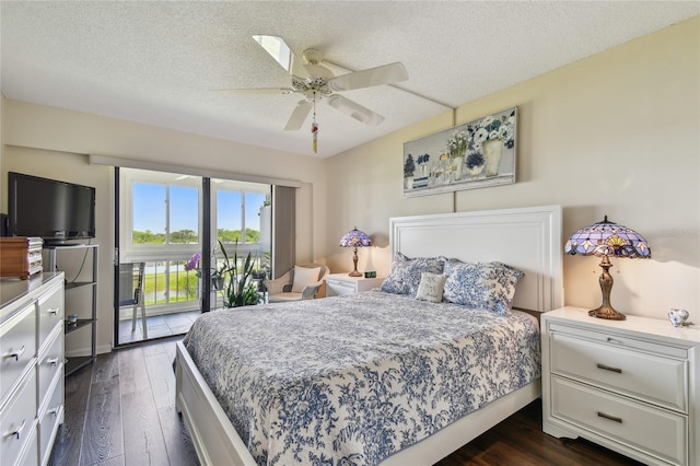 bedroom featuring access to outside, dark wood-style flooring, ceiling fan, and a textured ceiling