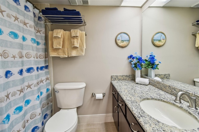 bathroom featuring visible vents, baseboards, toilet, vanity, and tile patterned floors