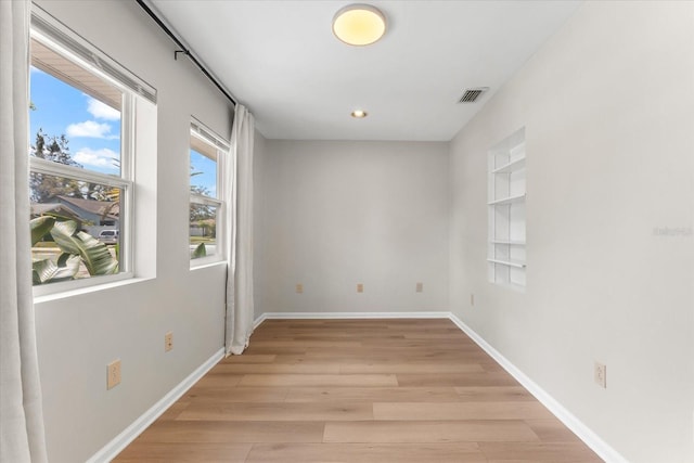 1232 Sedeeva Cir S, Clearwater, FL 33755 - spare room featuring light wood-style flooring, recessed lighting, and built in shelves