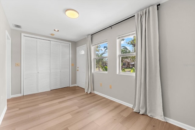 1232 Sedeeva Cir S, Clearwater, FL 33755 - unfurnished bedroom with light wood-style floors, a closet, and recessed lighting