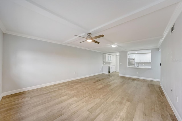 unfurnished living room with a sink, light wood-type flooring, a ceiling fan, and baseboards