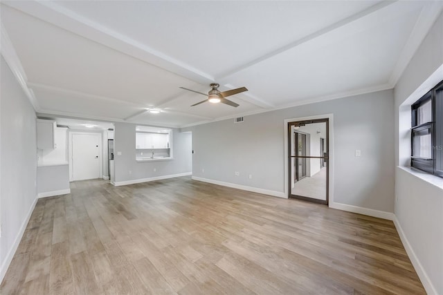 unfurnished living room featuring visible vents, baseboards, light wood-type flooring, a ceiling fan, and crown molding