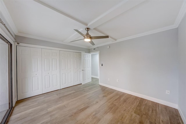 unfurnished bedroom featuring light wood-style floors, a ceiling fan, ornamental molding, baseboards, and beam ceiling
