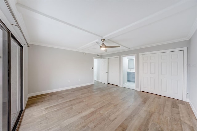 unfurnished bedroom featuring ornamental molding, baseboards, connected bathroom, and light wood-style floors