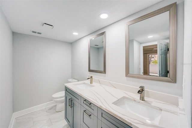 bathroom featuring visible vents, a sink, and toilet