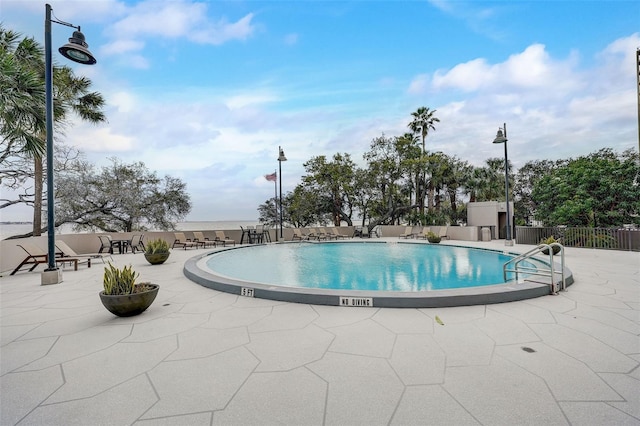 pool featuring a patio and fence