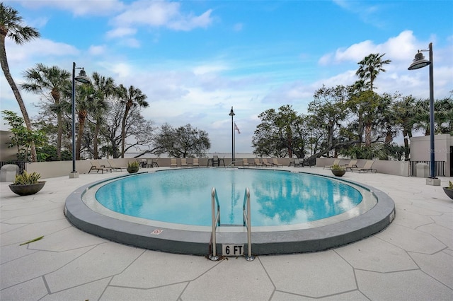 community pool featuring a patio area and fence