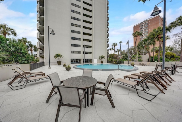 community pool with a patio area