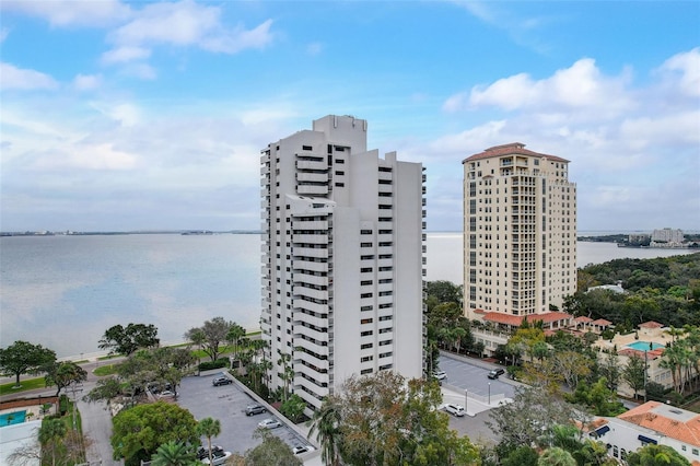 view of building exterior with a water view and a view of city