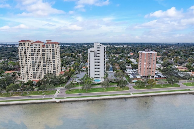 birds eye view of property with a water view and a city view