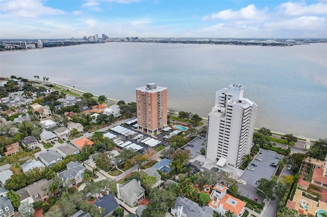 birds eye view of property featuring a water view and a city view